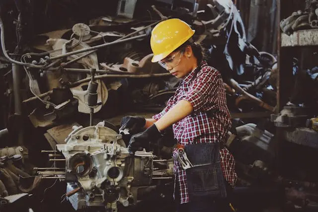 A female engineer working on machinery in a factory