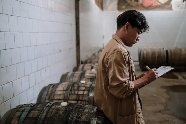 An employee inspecting barrels